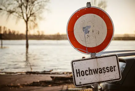 Warnschild Hochwasser vor einem Fluss